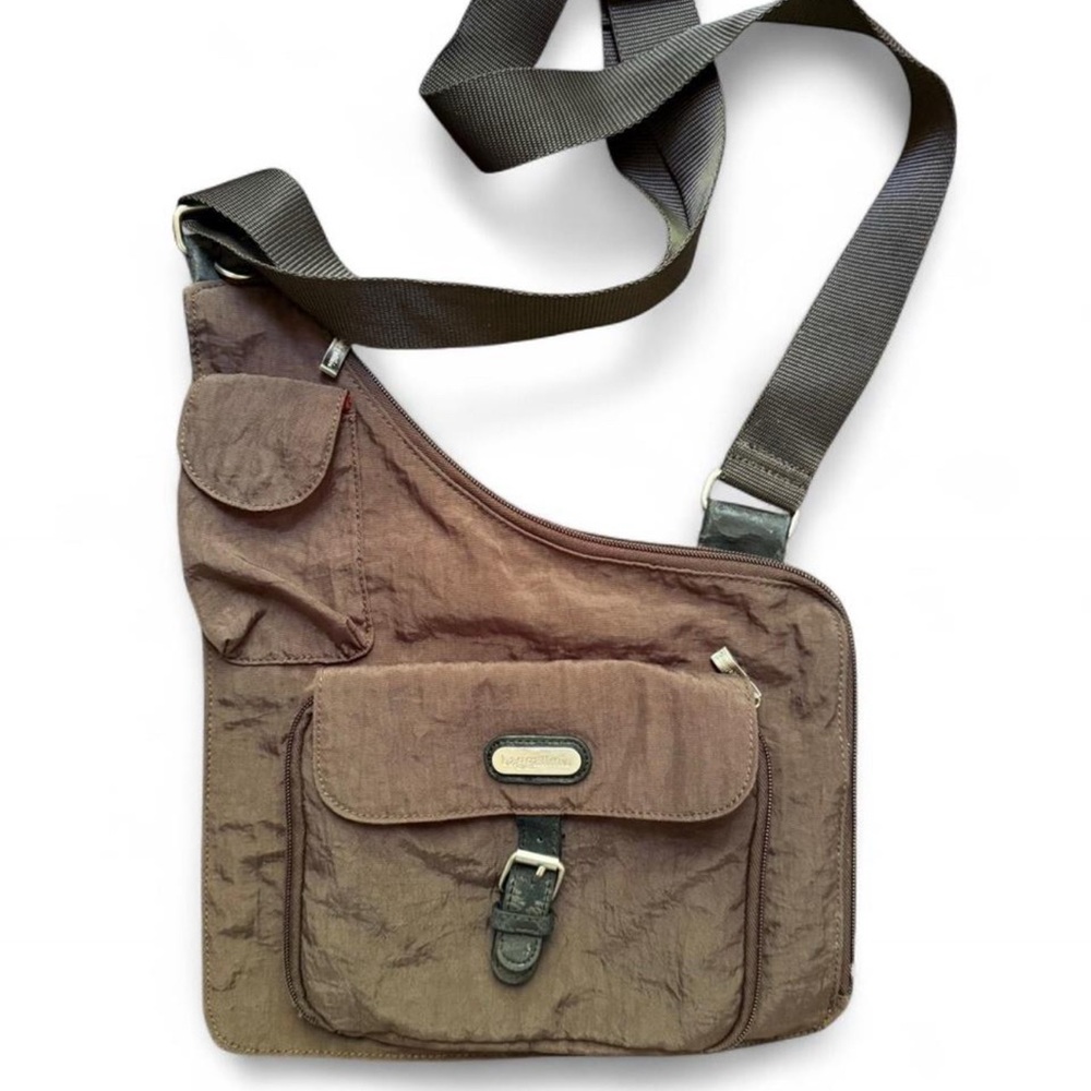 BAGGALLINI brown sling with red interior. Multiple pockets inside and out.
